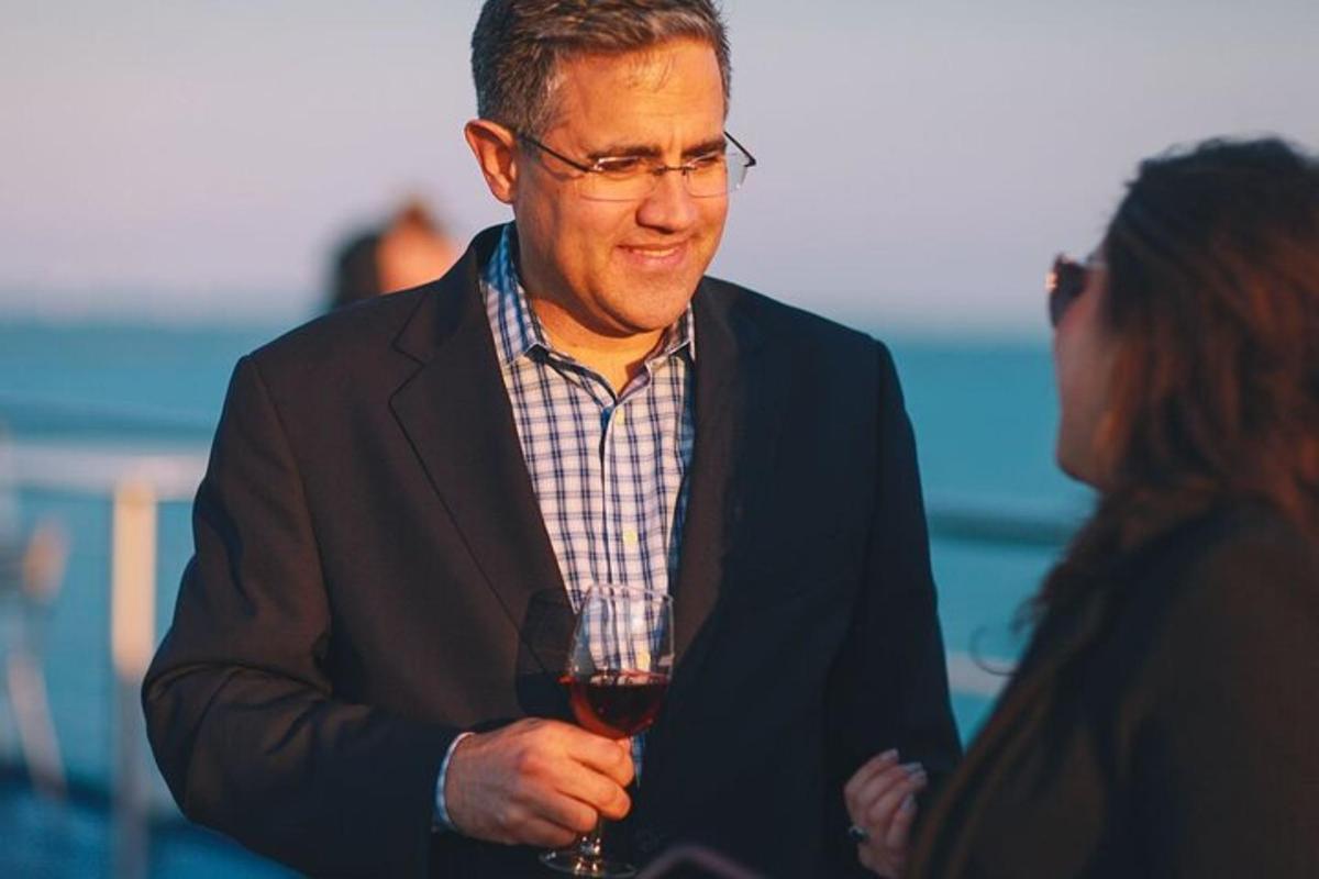 a man holding a glass of wine with a woman