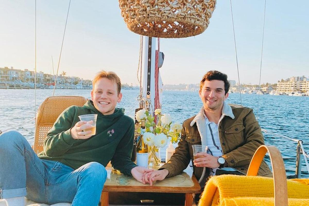 two men sitting at a table on a boat