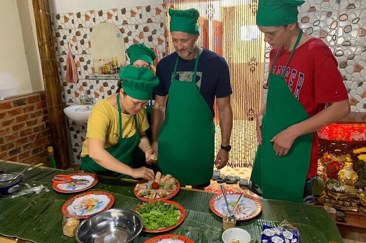 a group of men wearing green aprons preparing food