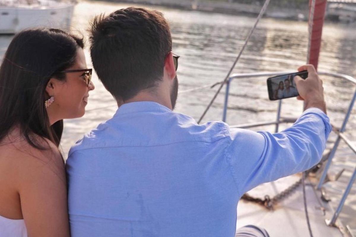 a man taking a picture of a woman on a boat