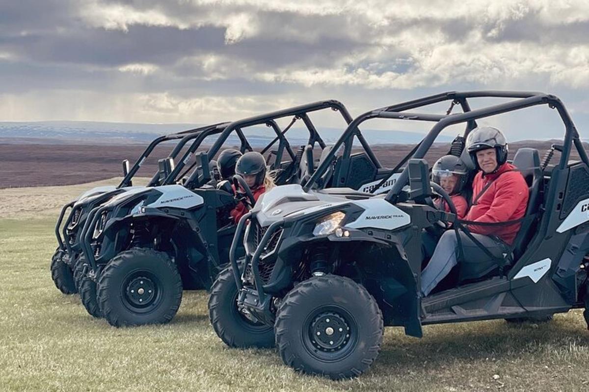 a group of people sitting in a four wheeler
