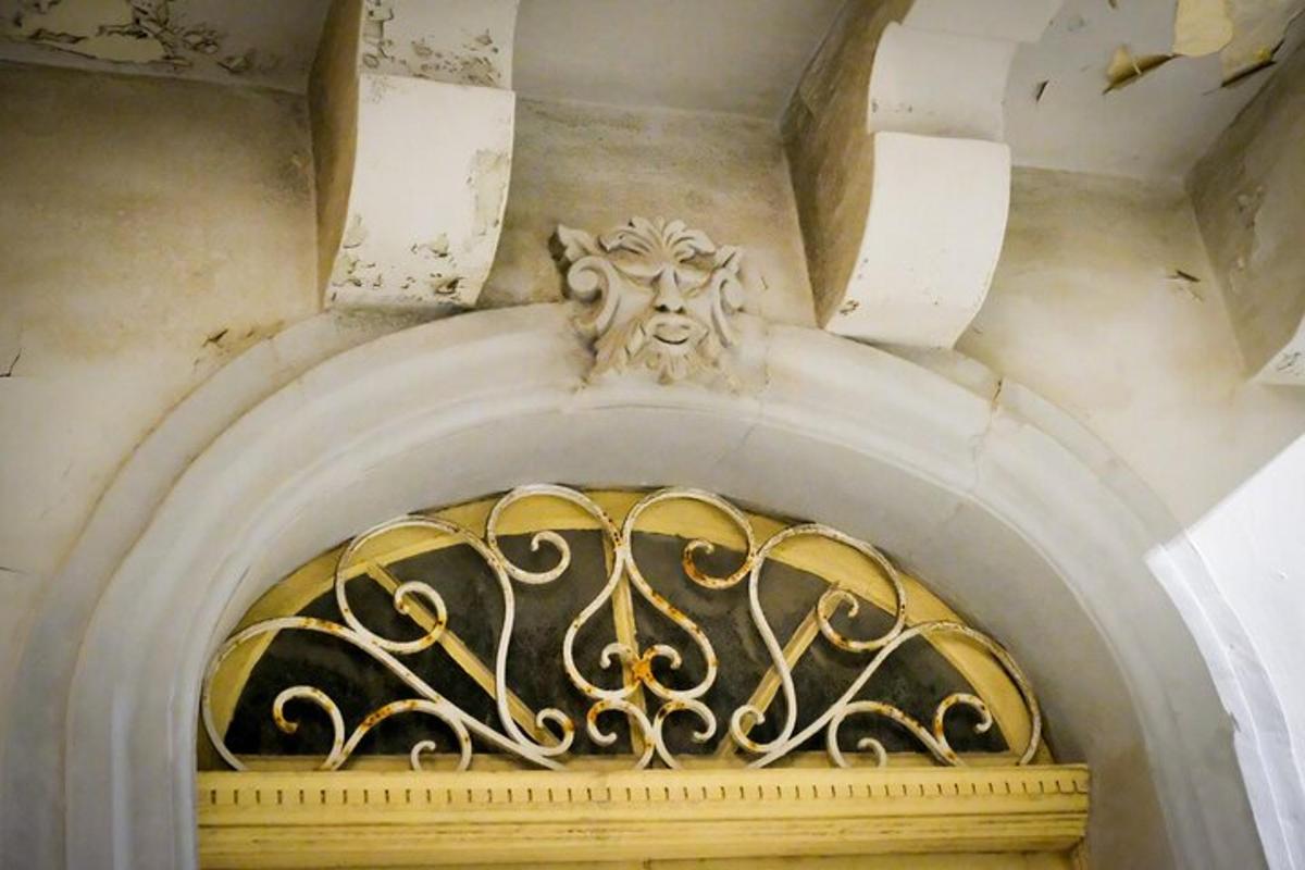 an archway with a gold railing on a building