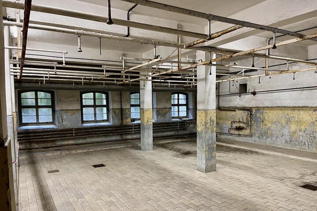 an empty room with columns and windows in an old building