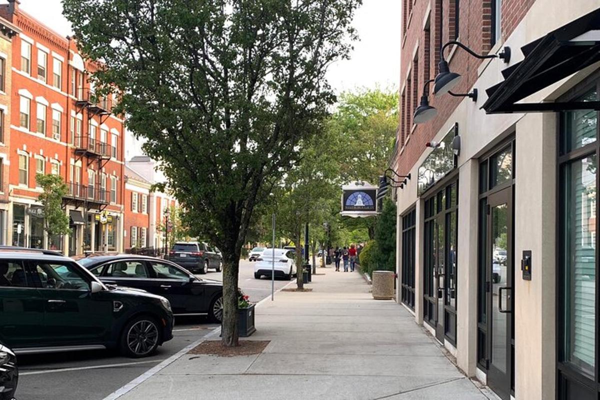 a city street with cars parked on the sidewalk