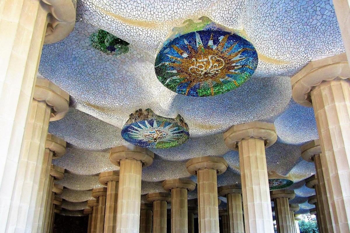 a lobby with blue glass chandeliers on a ceiling