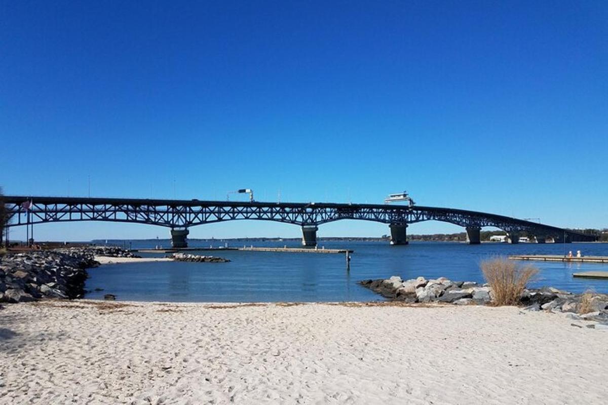 a bridge over a body of water with a beach