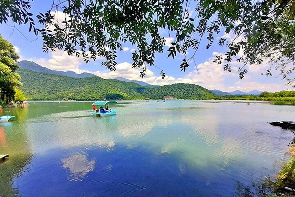 a boat on a lake with mountains in the background
