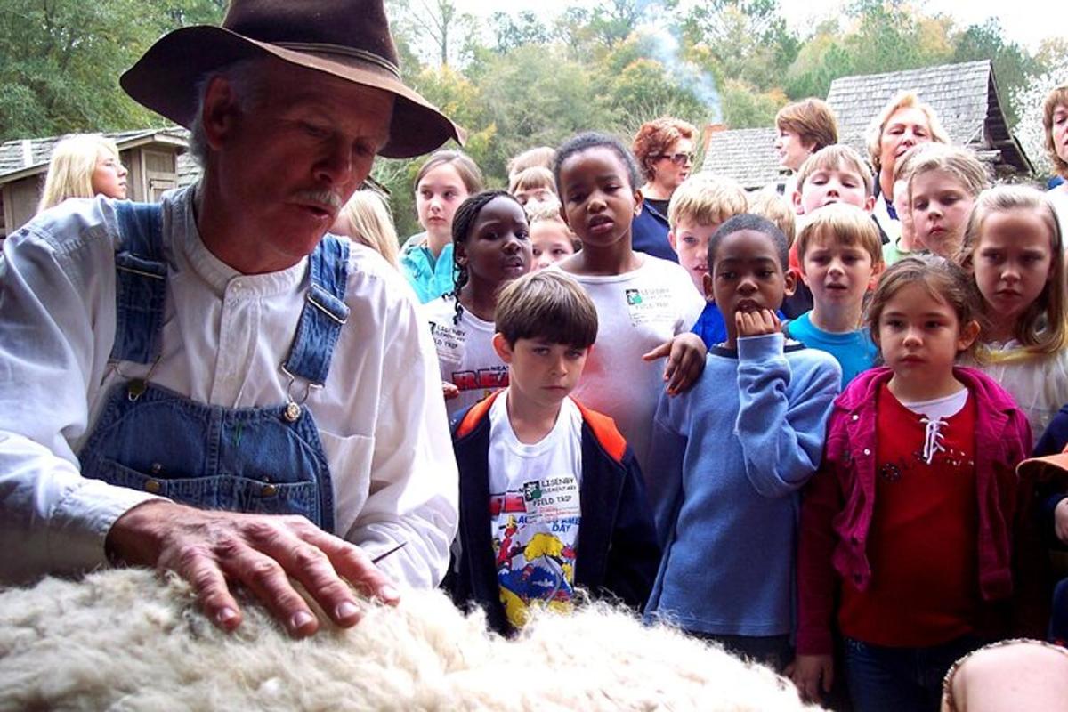 a man standing in front of a group of children
