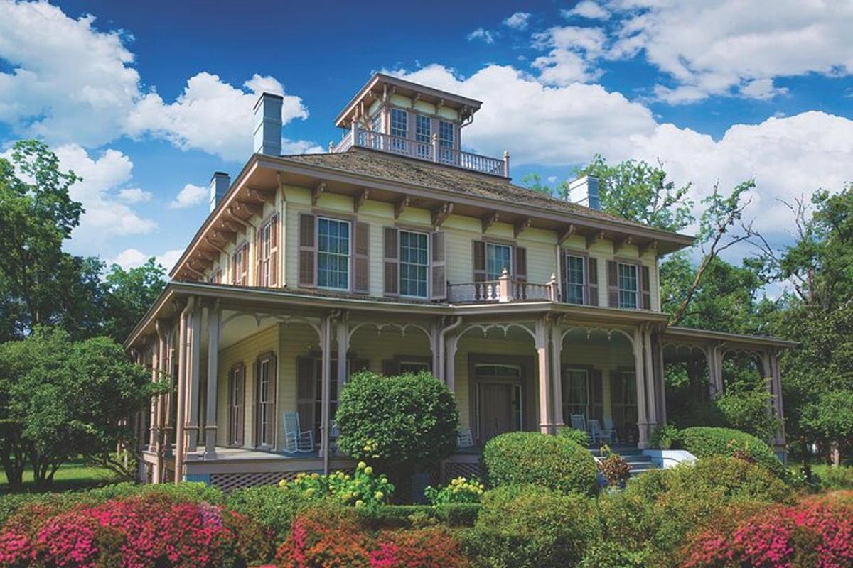 an old house with a tower on top of it