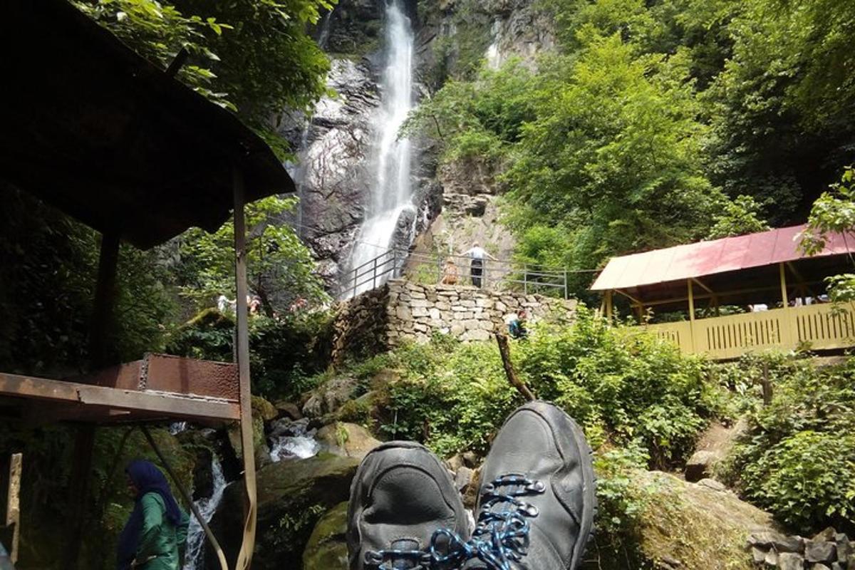 a person standing in front of a waterfall