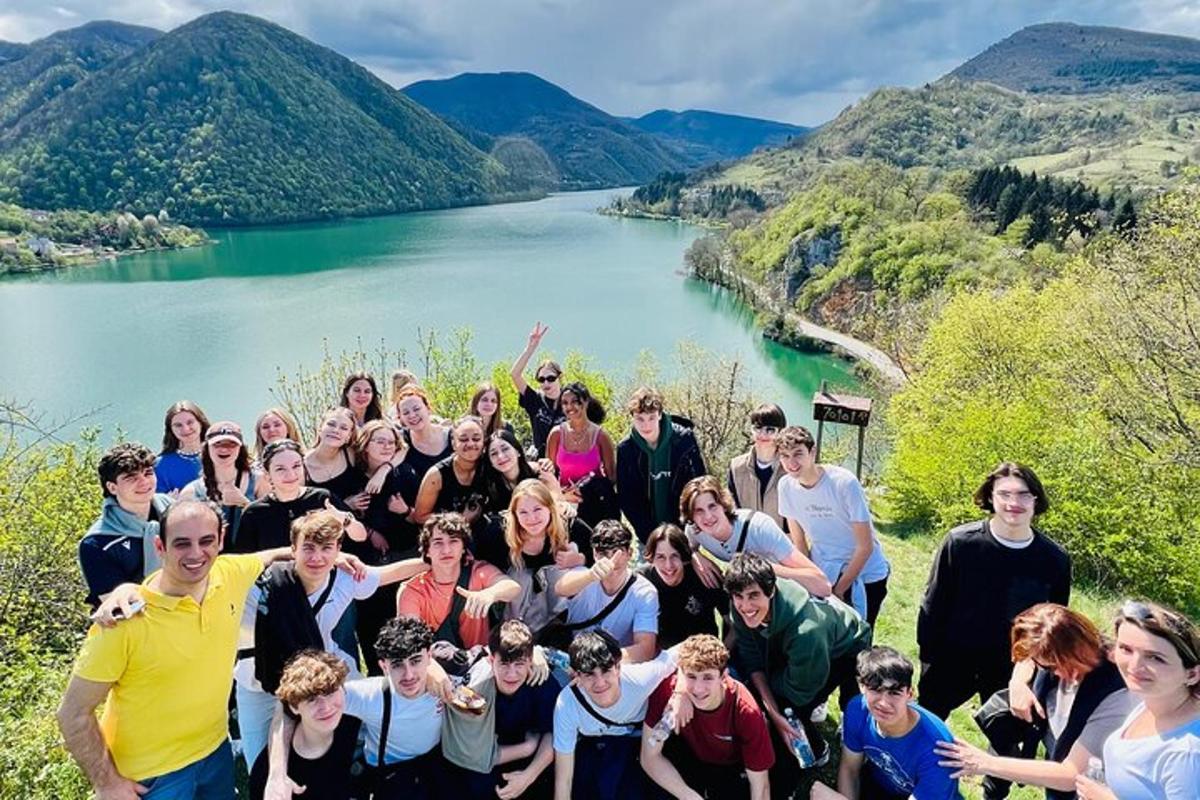a group of people posing for a picture in front of a river