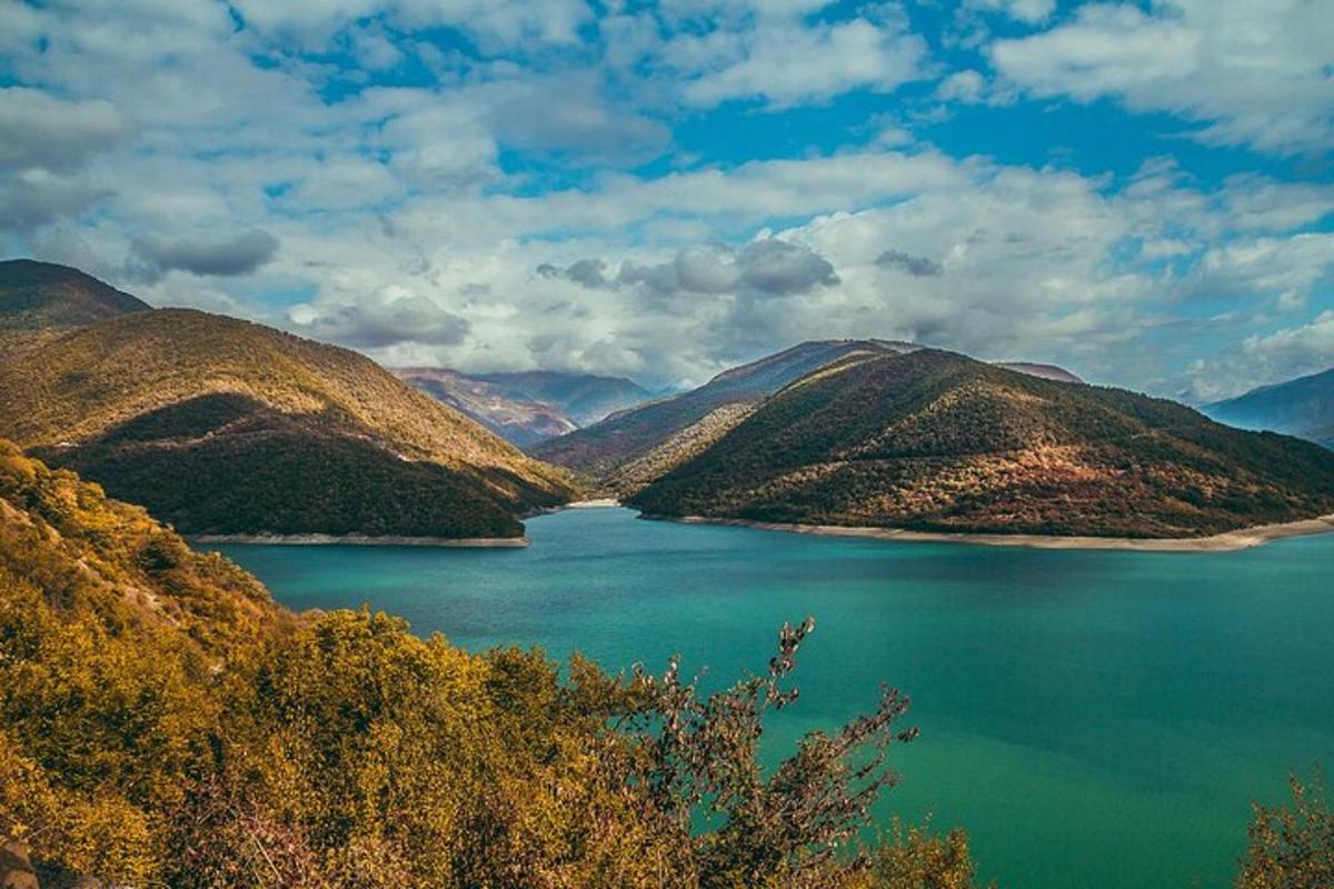 a large body of water with mountains in the background