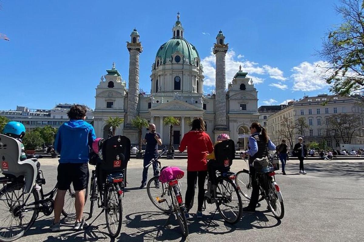 en grupp människor som står med cyklar framför en byggnad