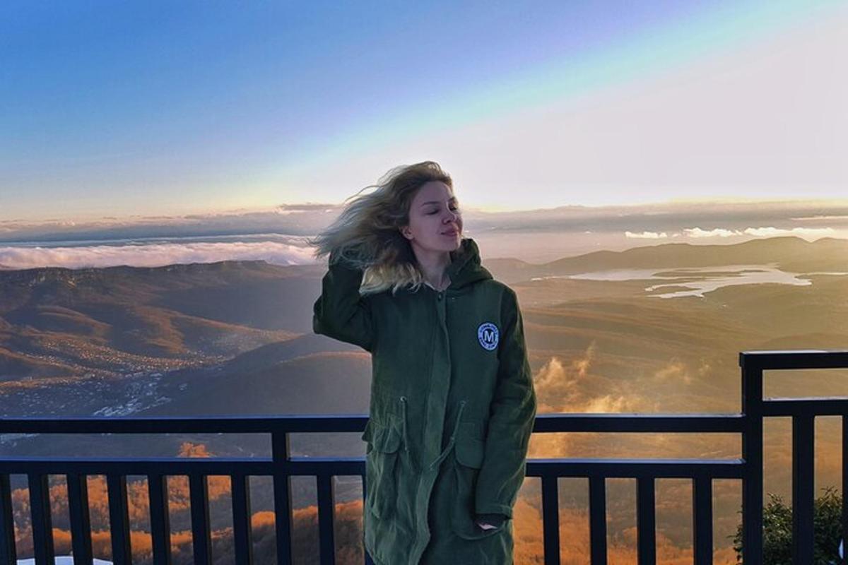 a woman standing on top of a mountain