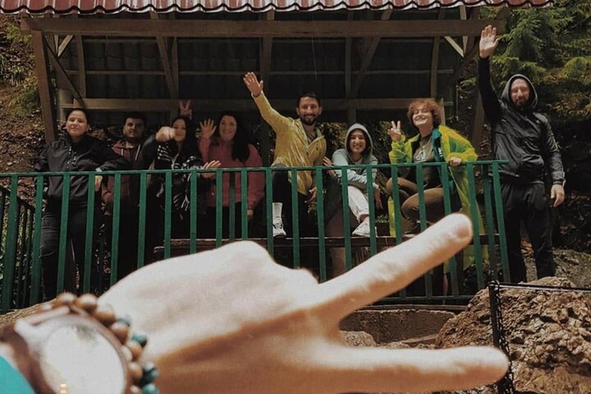 a group of people standing behind a fence