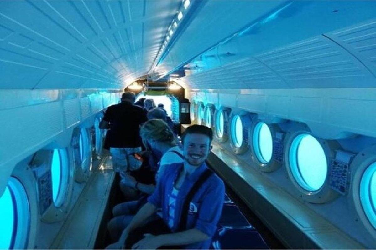 a group of people sitting on an airplane aisle
