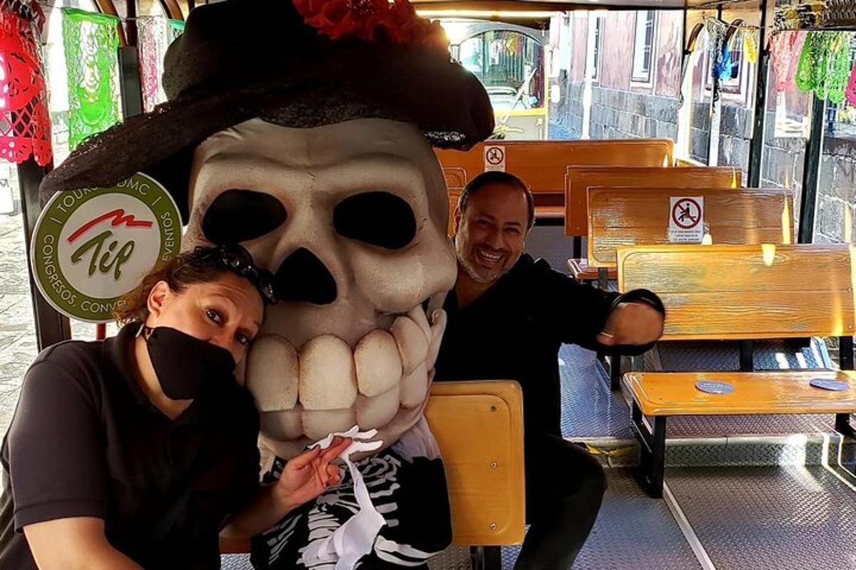 a man and woman sitting next to a mask