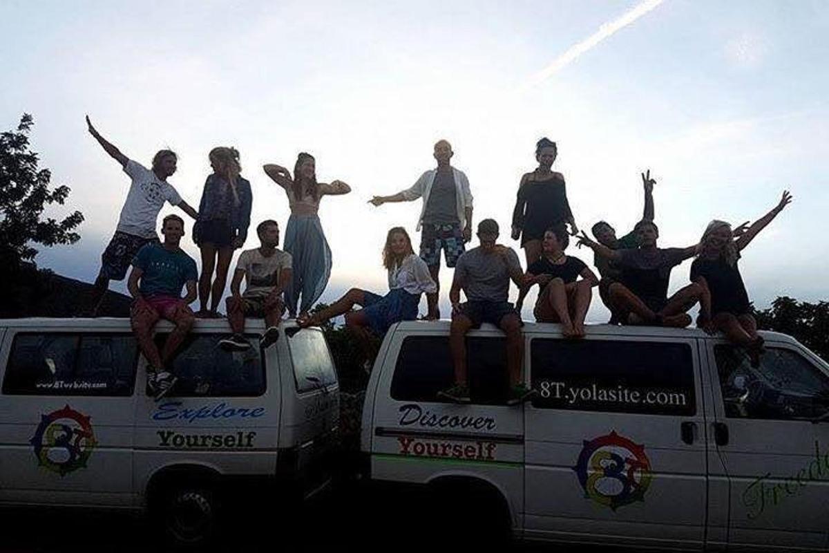 a group of people sitting on the back of a truck