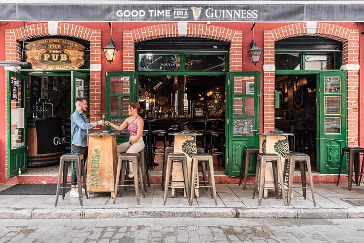 a man and a woman sitting in front of a bar