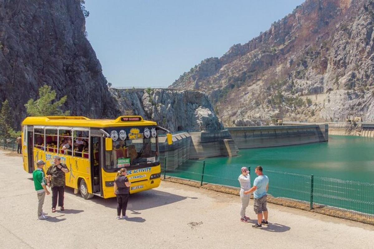 a group of people standing around a yellow bus