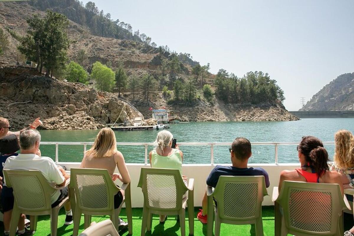 a group of people sitting on a boat on the water