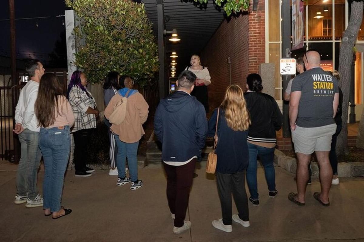 a group of people walking down a sidewalk