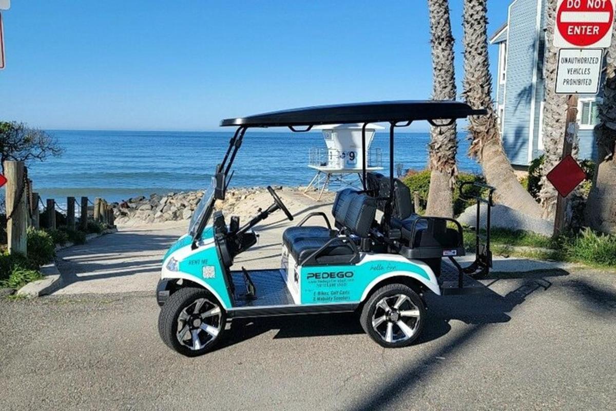 a golf cart parked next to the beach