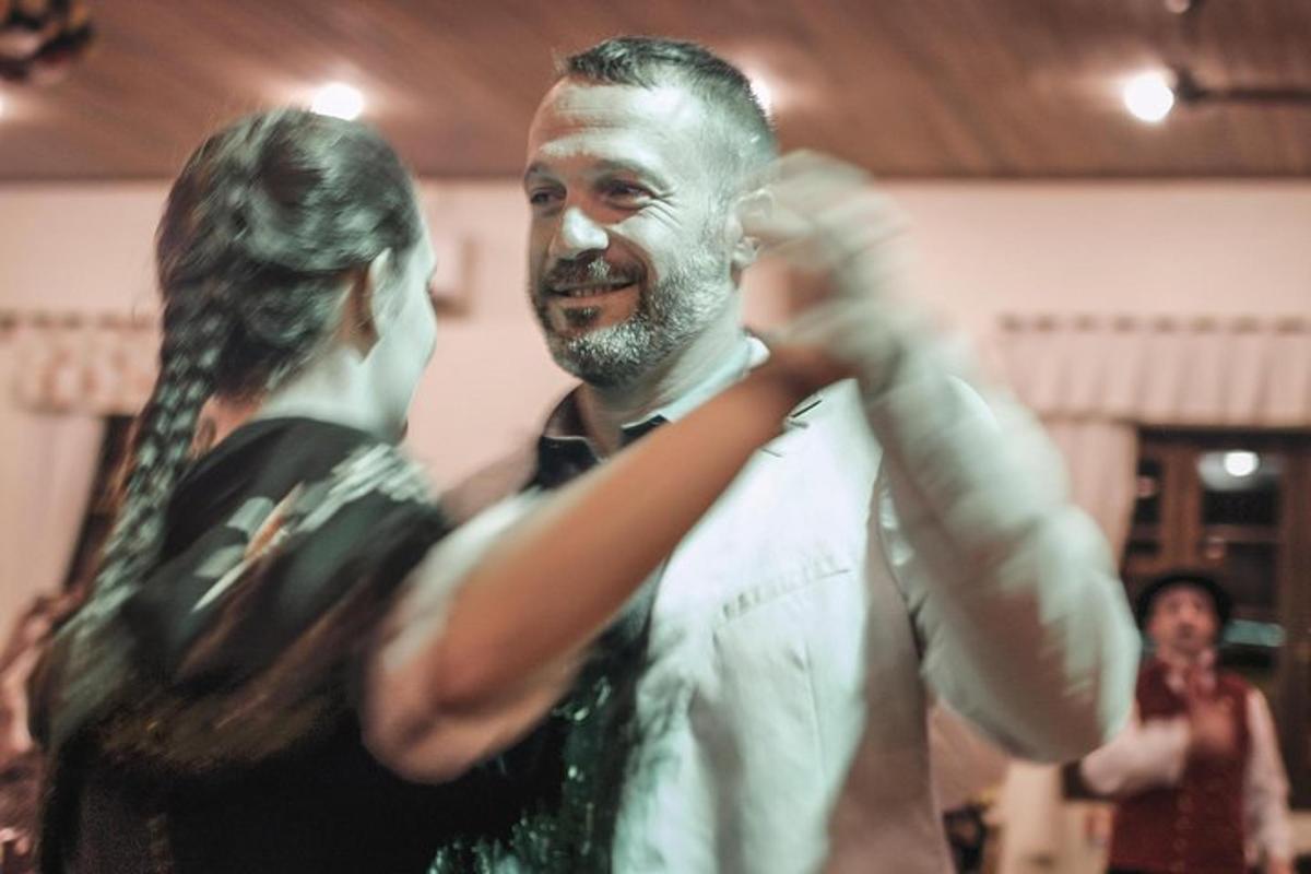 a woman helping a man fix his tie
