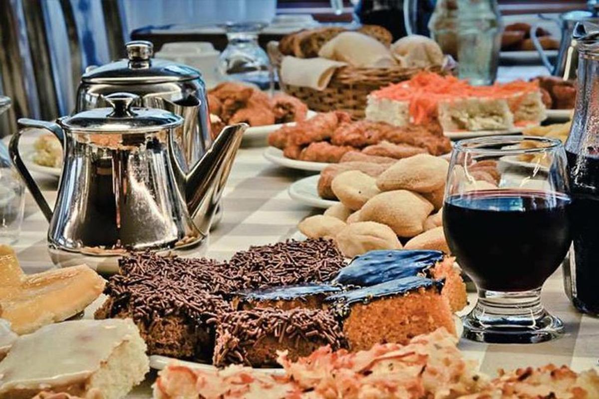 a table topped with different types of food and a glass of wine