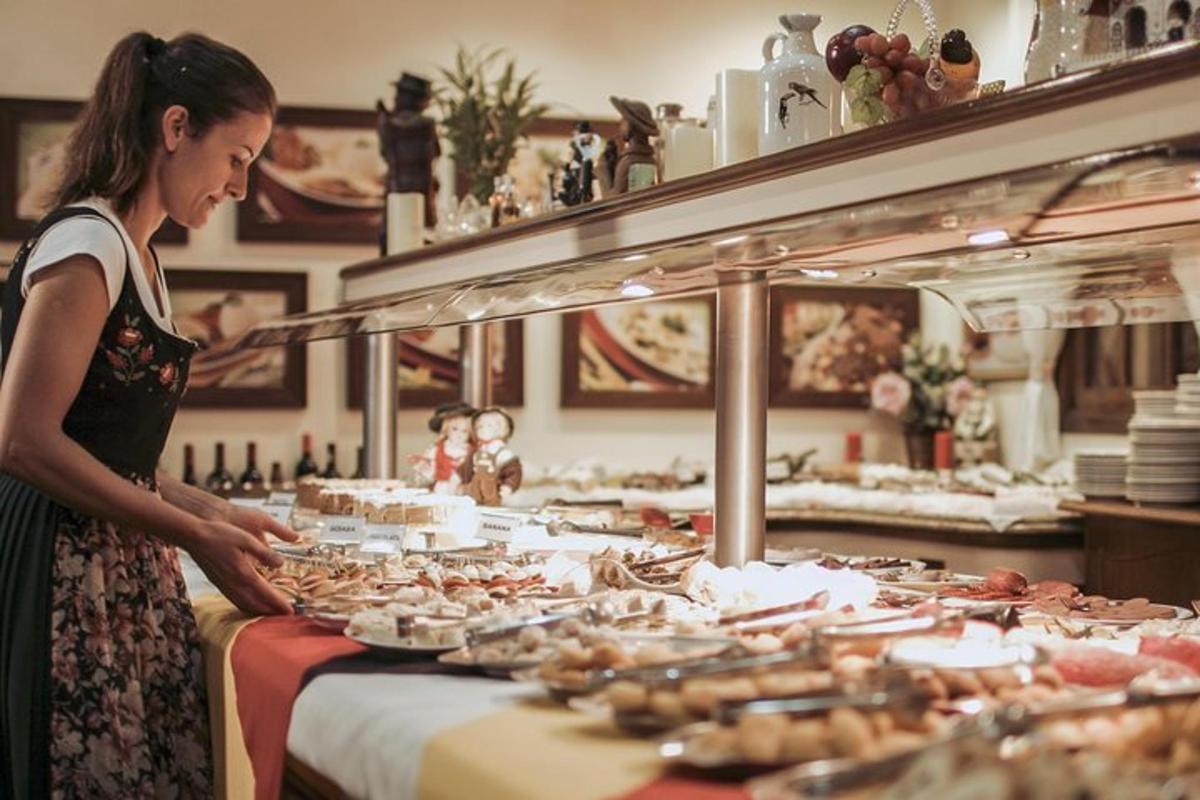 a woman standing in front of a buffet of food