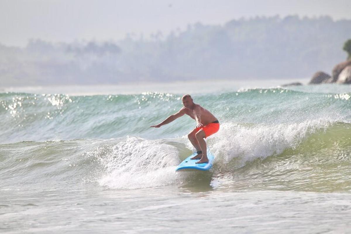 a man riding a wave on a surfboard in the ocean