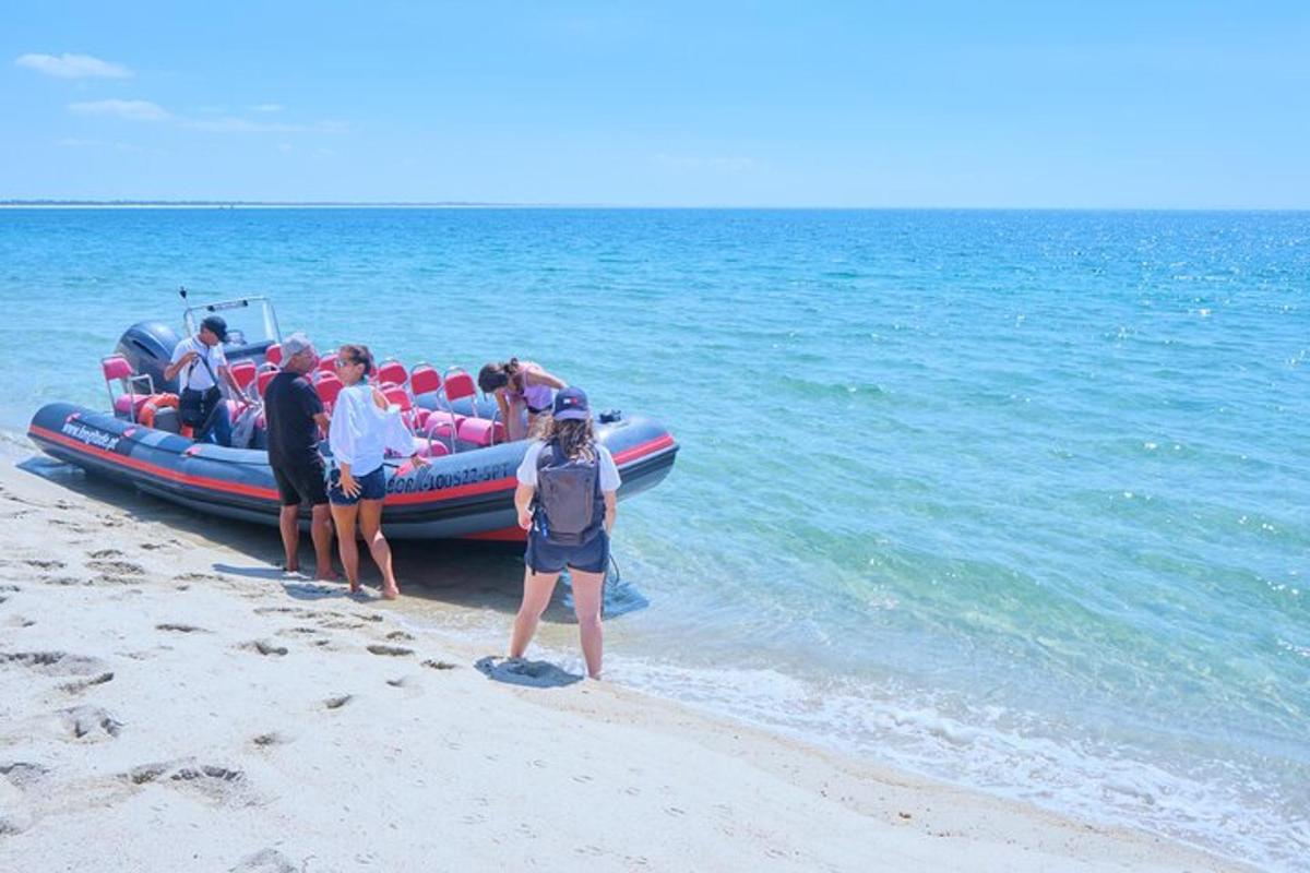 a group of people standing on a beach next to a boat