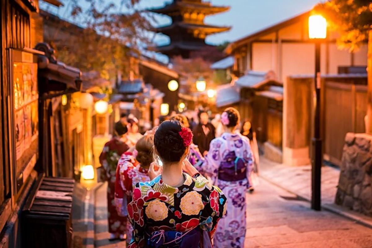 a group of people in kimonos walking down a street
