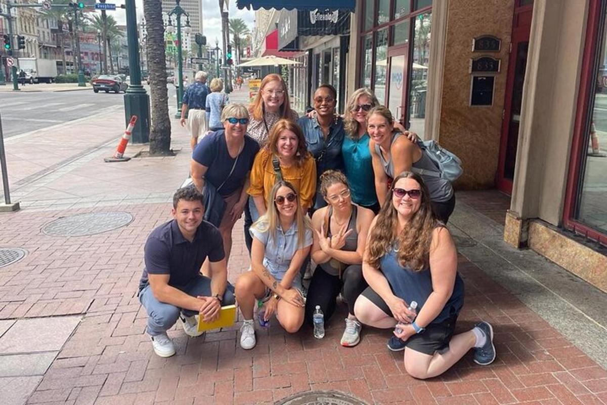 a group of people posing for a picture on the sidewalk