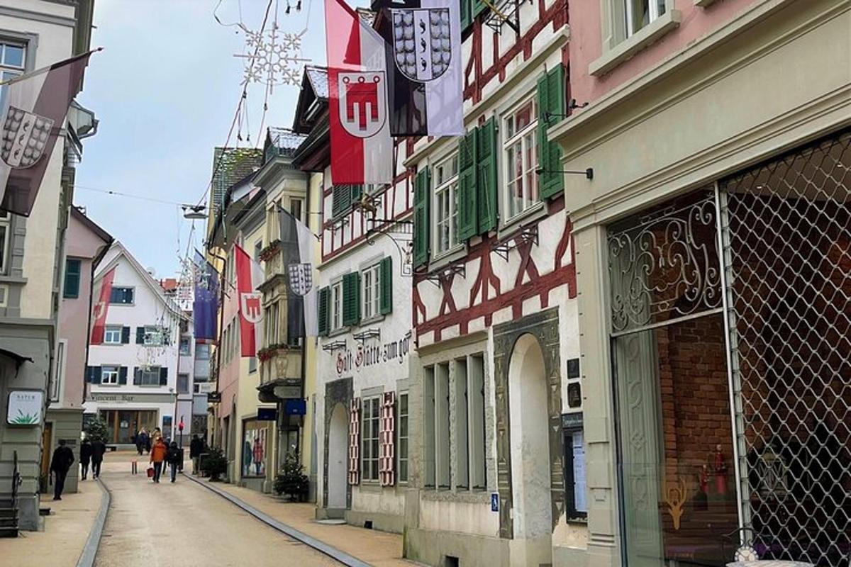 a city street with buildings and people walking down the street