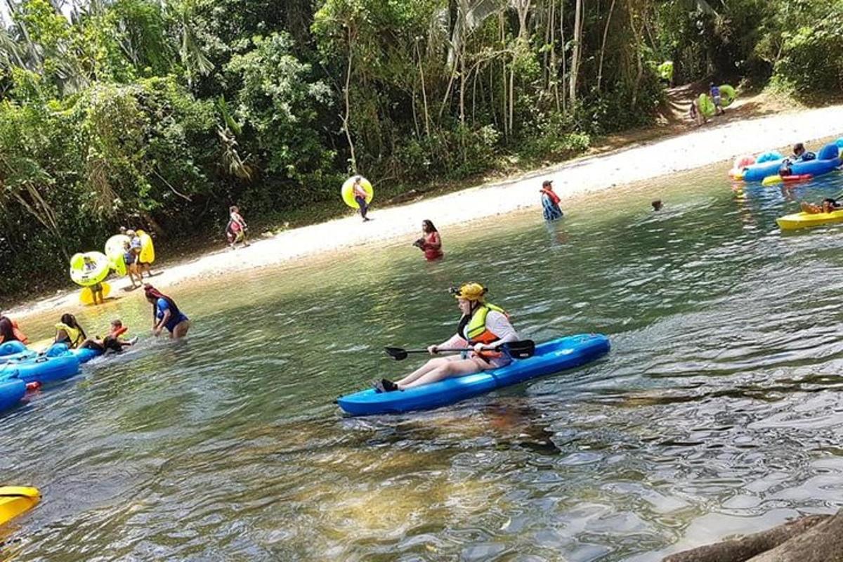 a group of people on kayaks in the water on a beach