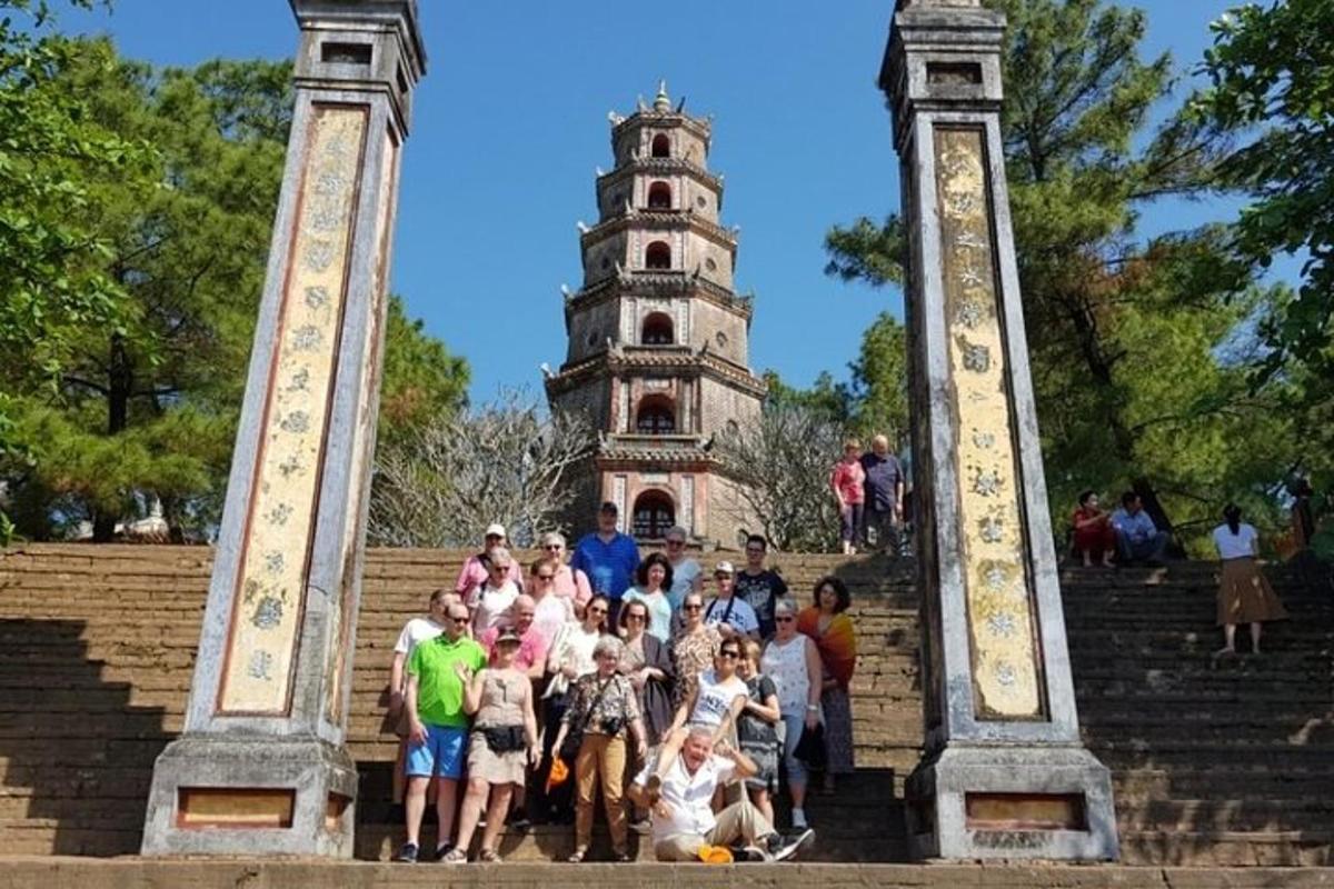 a group of people standing on steps in front of a tower