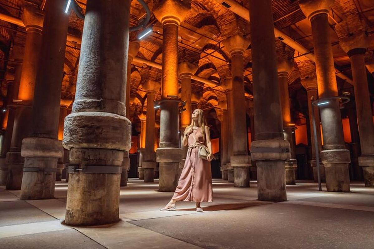 a woman standing inside of a building with columns