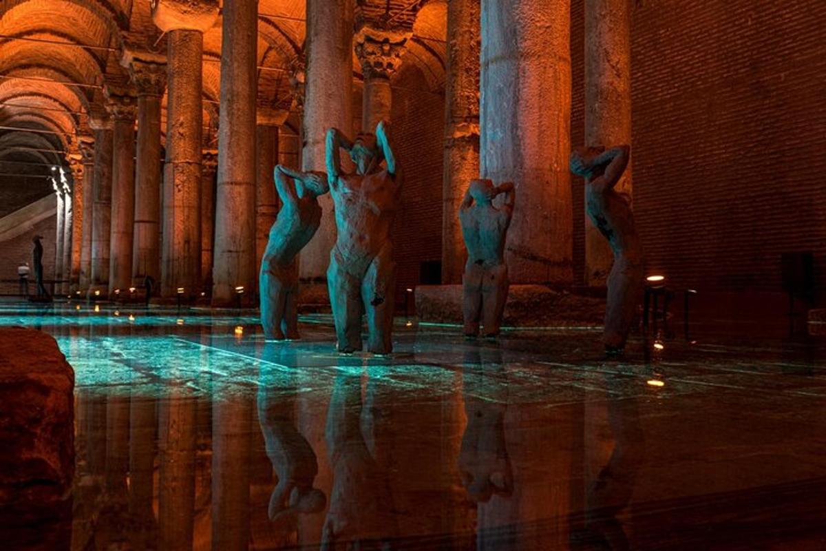 a group of statues standing in a building with their reflections