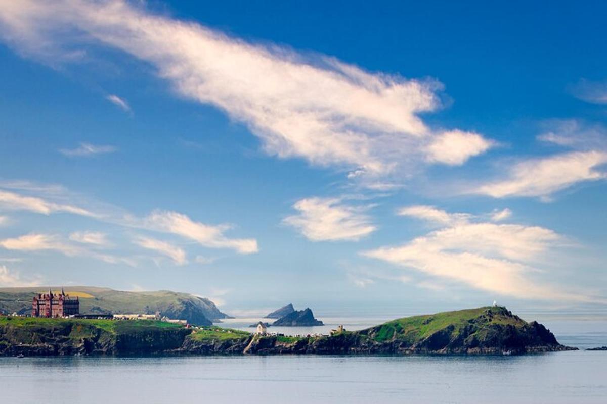 an island in the water with a cloudy sky
