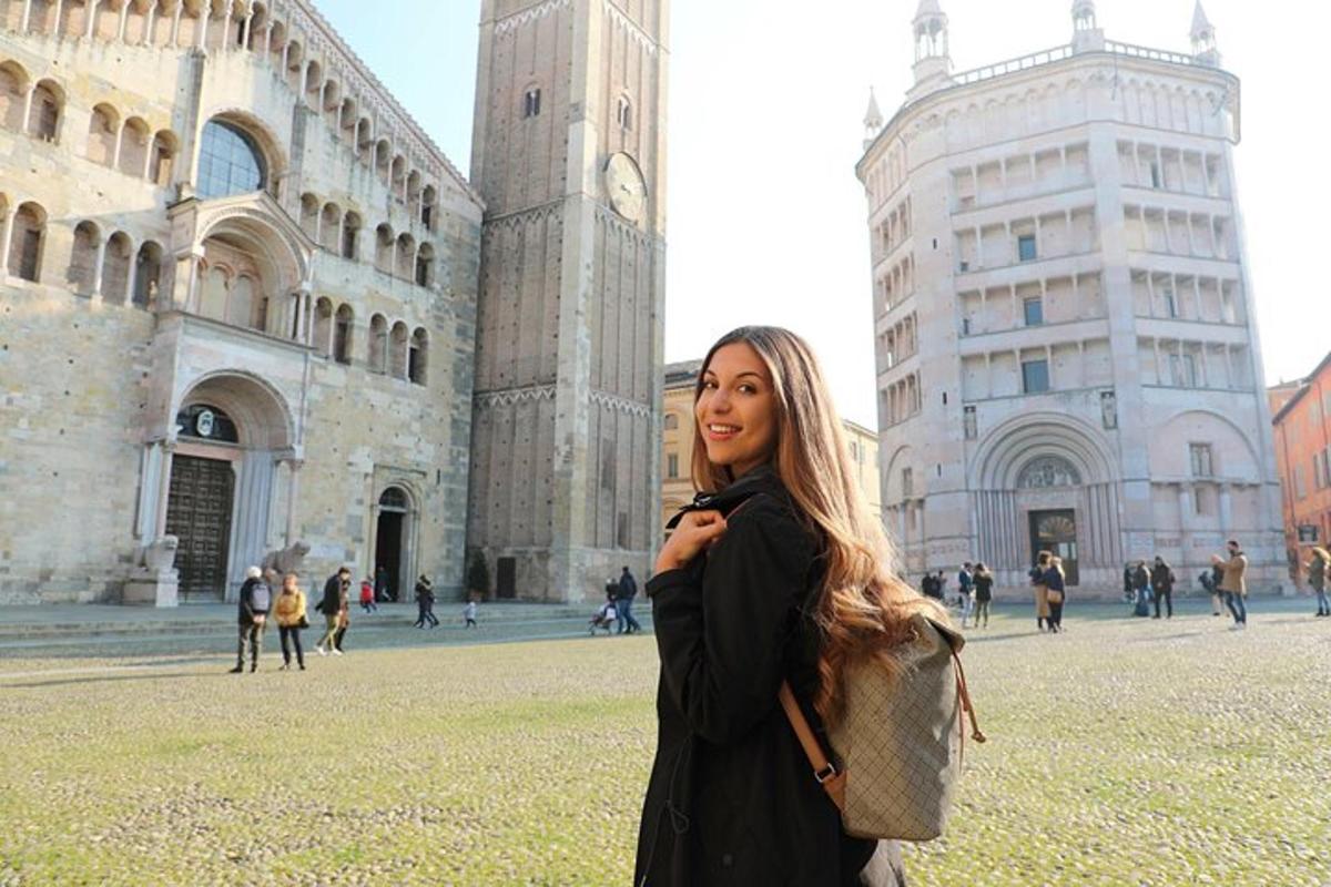 a woman standing in front of a building with a clock tower