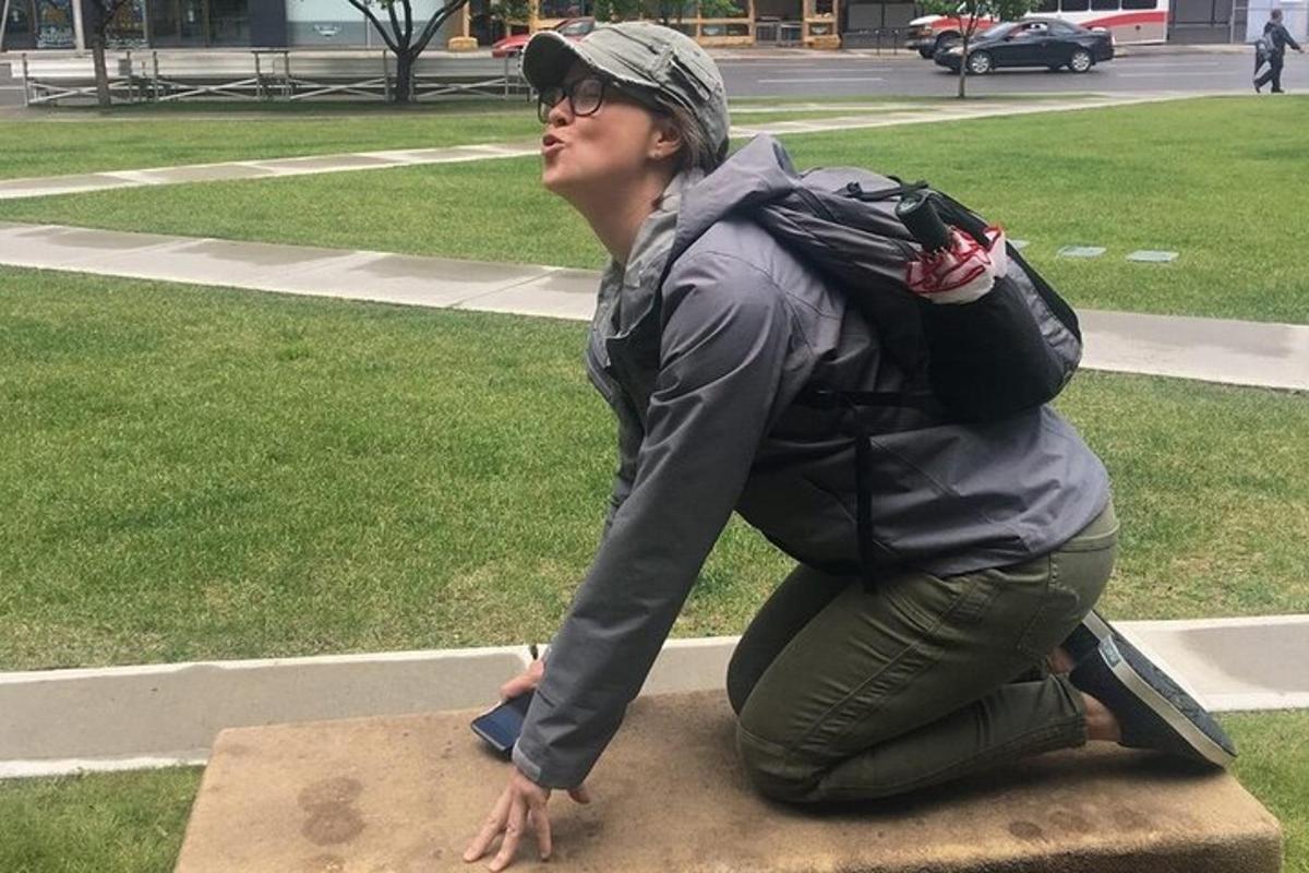a woman with a backpack sitting on a rock