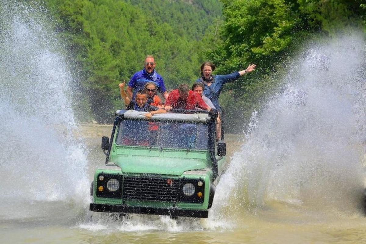 eine Gruppe von Menschen, die in einem Jeep im Wasser fahren