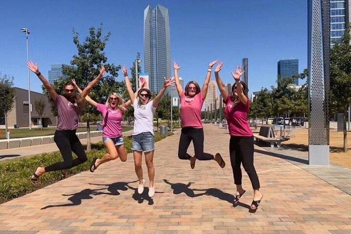 a group of people jumping in the air in a park