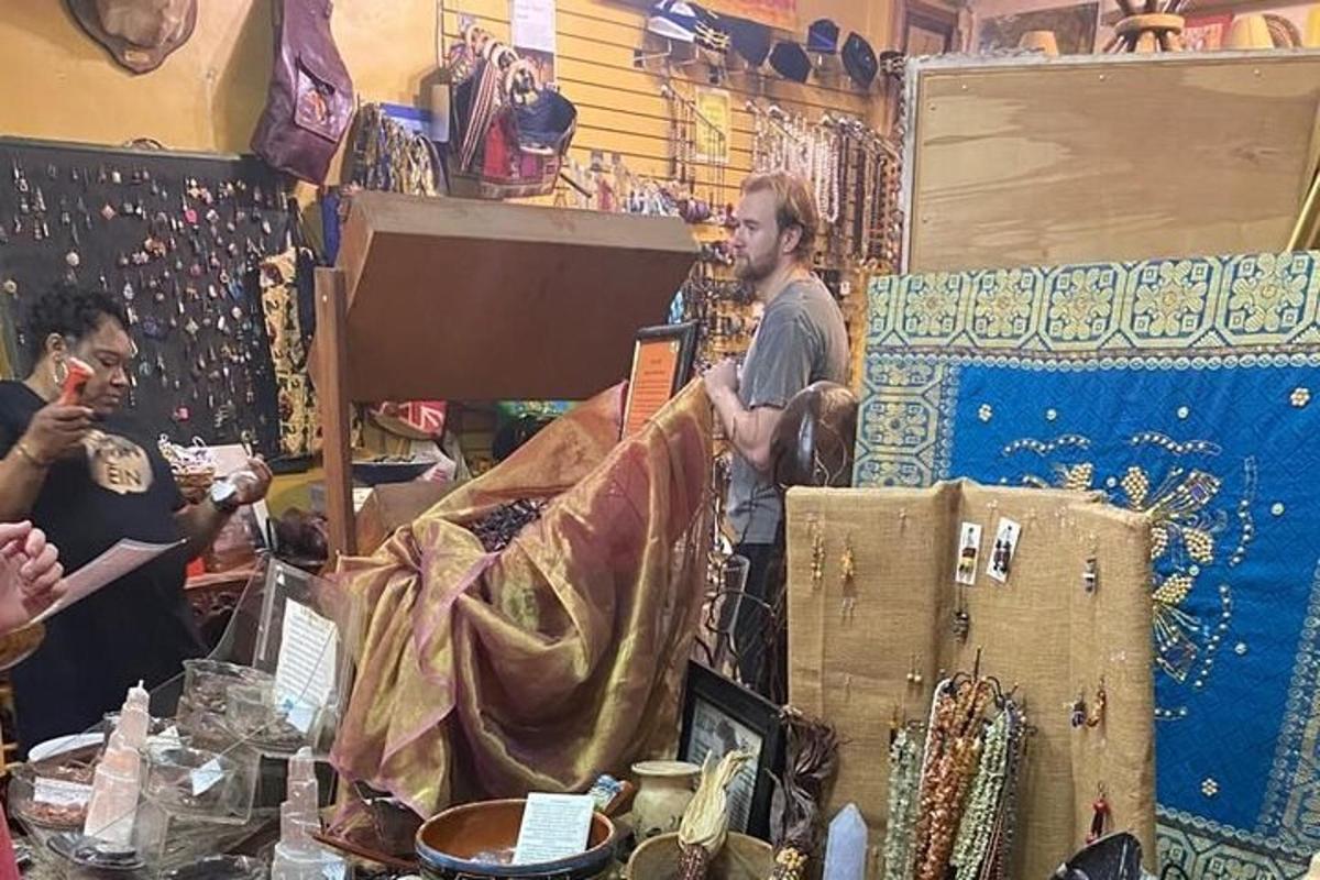 a group of people standing in a shop selling items