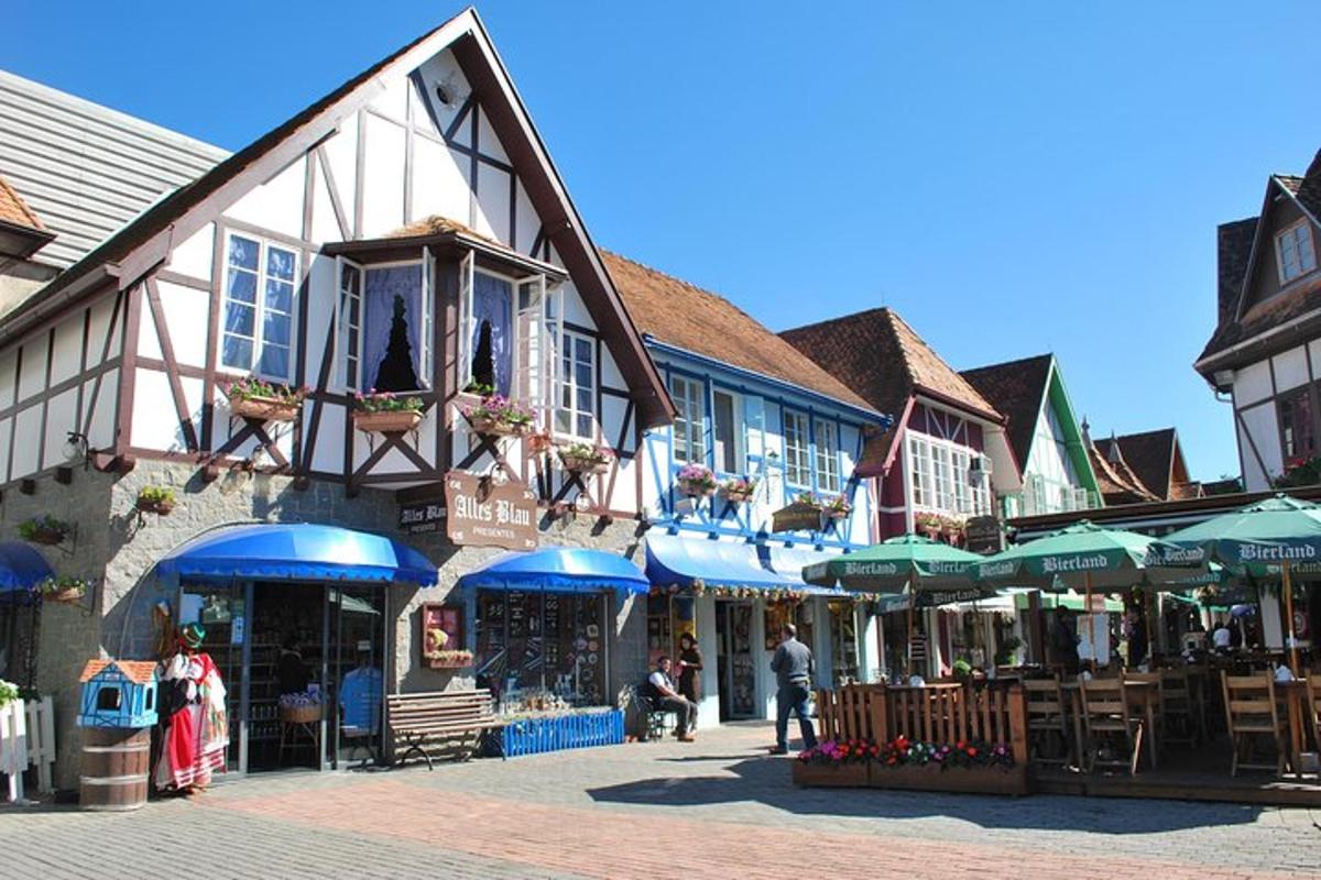 a group of buildings with tables and umbrellas