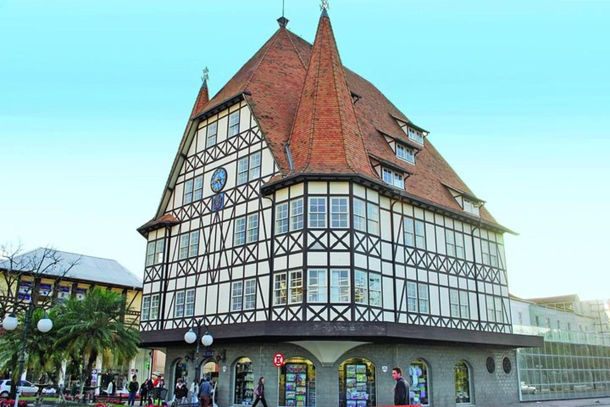 a tall building with a roof with people standing outside