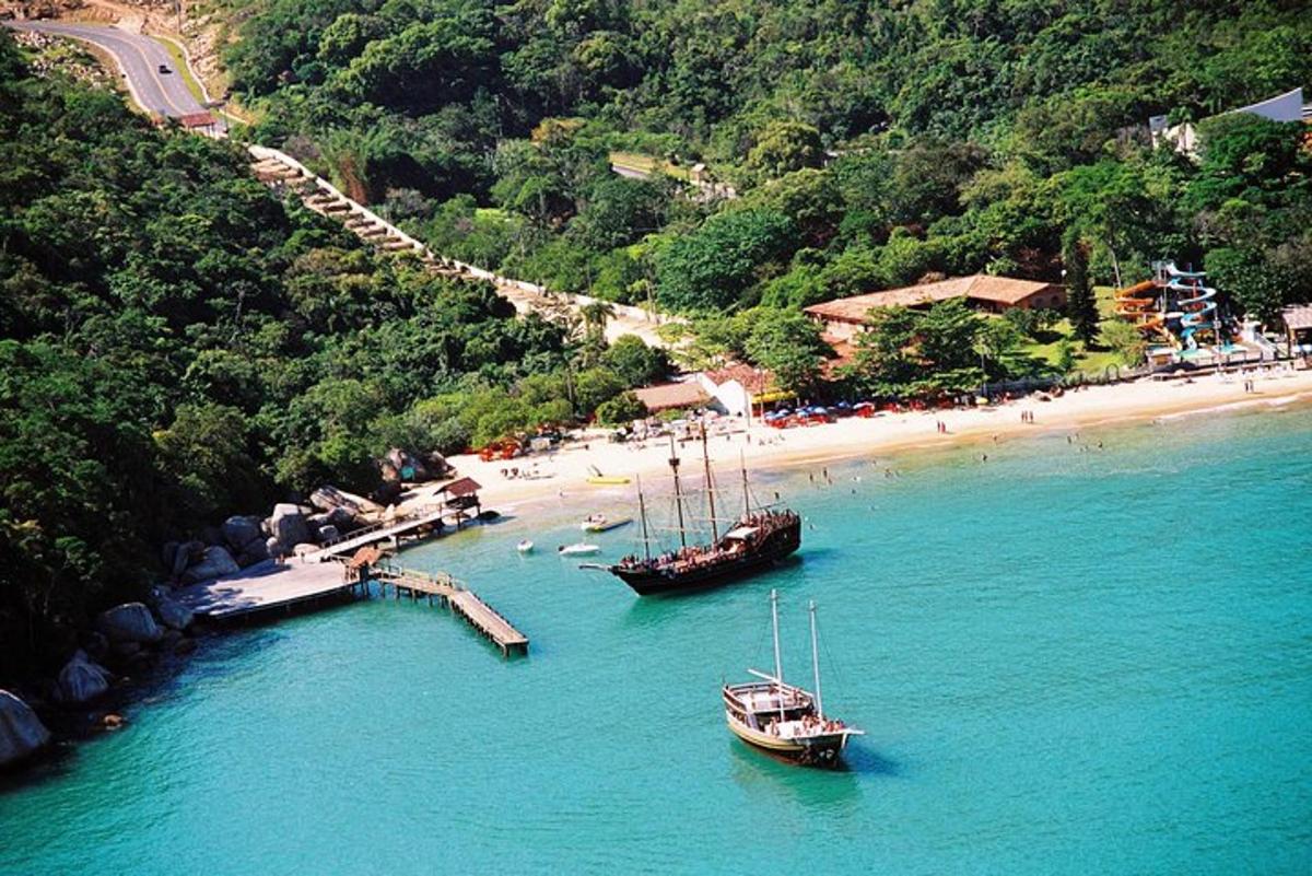 two boats in the water near a beach