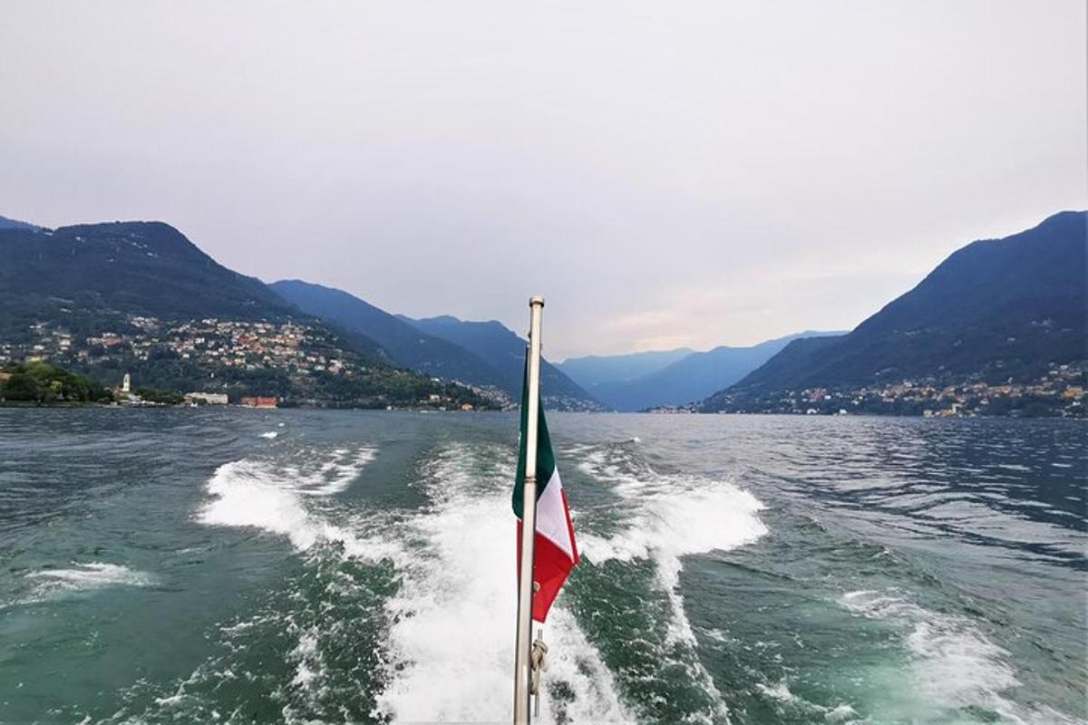 a boat with a flag on the water