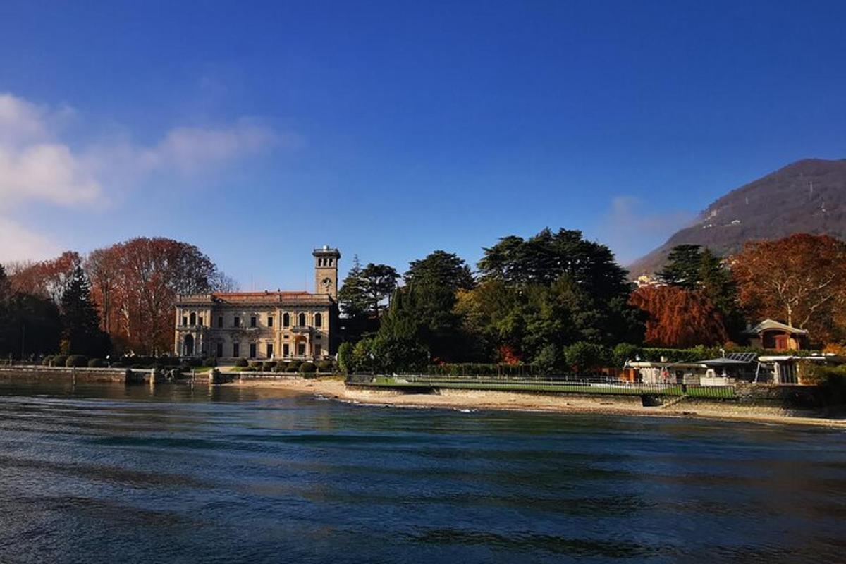 a building with a clock tower next to a river